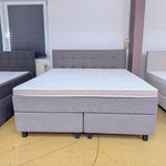 Boxspringbett Mats 180x200 in Taupe mit rechteckig gestepptem Kopfteil, Kaltschaumtopper und schwarzen Holzfüßen, Frontansicht